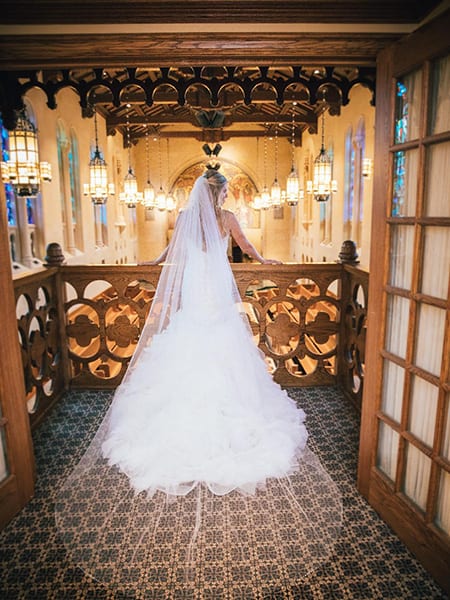A bride in her wedding dress walking down the aisle.